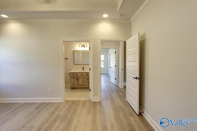 corridor featuring crown molding and light hardwood / wood-style floors