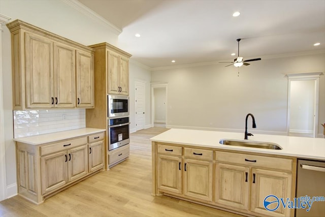 kitchen with sink, crown molding, stainless steel appliances, light brown cabinetry, and light wood-type flooring