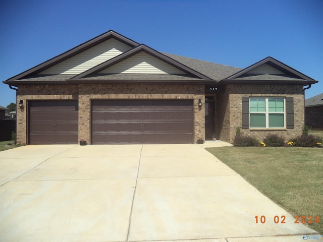 319 Jackson Point Cir, Huntsville, AL 35811 - view of front of house with driveway, an attached garage, and brick siding