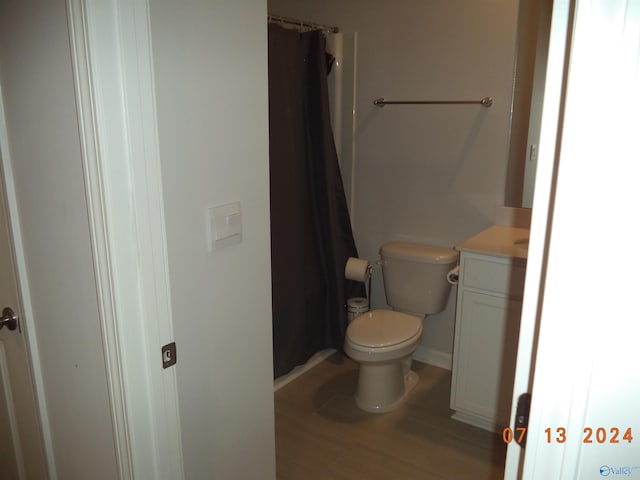 319 Jackson Point Cir, Huntsville, AL 35811 - bathroom with toilet, vanity, baseboards, a shower with shower curtain, and wood finished floors