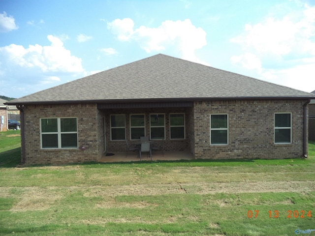 319 Jackson Point Cir, Huntsville, AL 35811 - back of property with roof with shingles, brick siding, a patio area, and a lawn