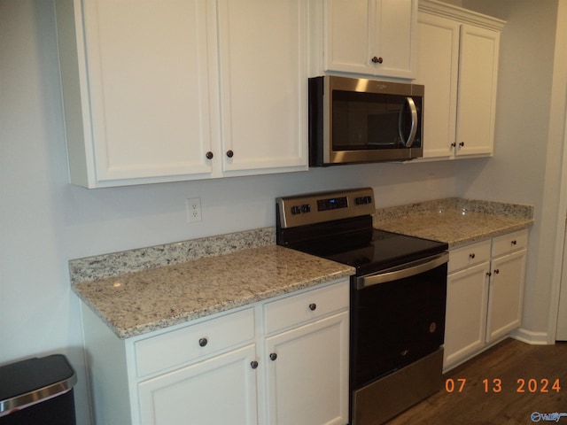 319 Jackson Point Cir, Huntsville, AL 35811 - kitchen featuring stainless steel appliances, white cabinetry, light stone counters, and dark wood finished floors