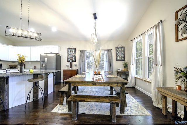 dining room featuring dark hardwood / wood-style floors and lofted ceiling