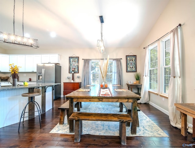 dining room with vaulted ceiling and dark hardwood / wood-style floors