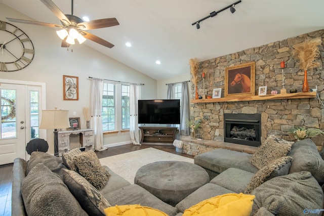 living room with a wealth of natural light, dark wood-type flooring, and lofted ceiling