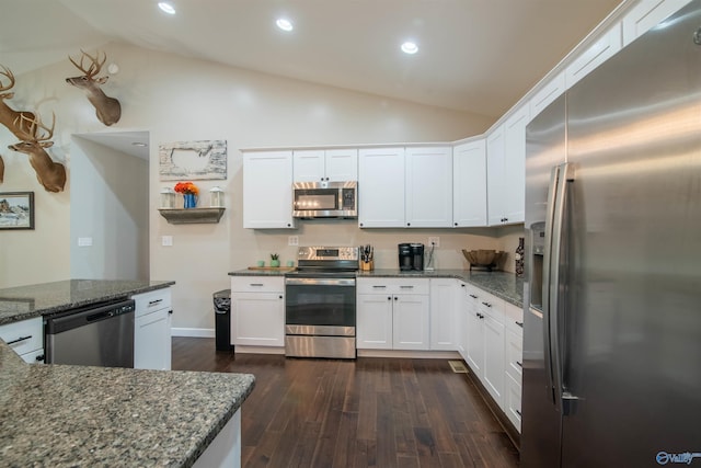 kitchen featuring high vaulted ceiling, white cabinets, dark stone countertops, dark hardwood / wood-style flooring, and stainless steel appliances