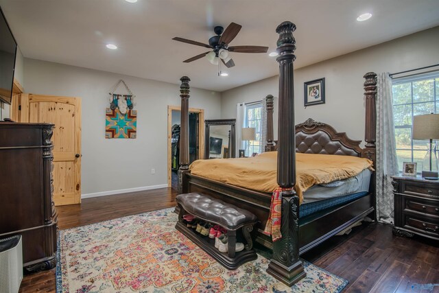 bedroom with multiple windows, ceiling fan, and dark wood-type flooring