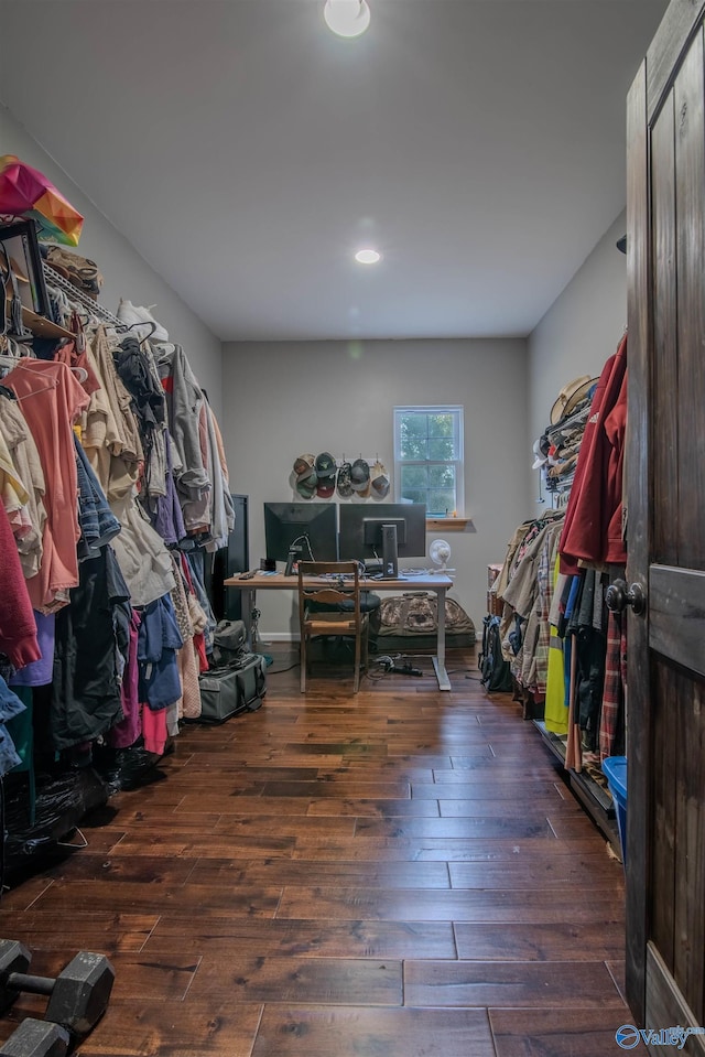 spacious closet with dark hardwood / wood-style flooring