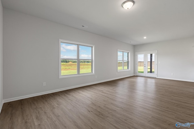 spare room featuring recessed lighting, visible vents, baseboards, and dark wood-style floors