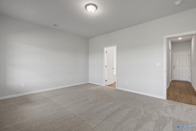 spare room with visible vents, baseboards, recessed lighting, and carpet