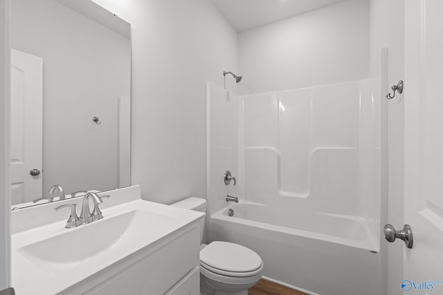 bathroom with vanity, bathtub / shower combination, toilet, and wood finished floors