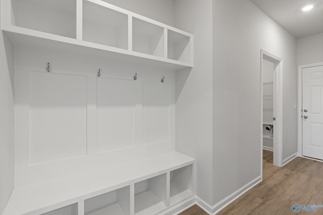 mudroom featuring wood finished floors, baseboards, and recessed lighting