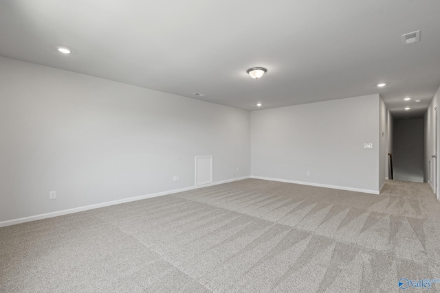 spare room featuring visible vents, baseboards, recessed lighting, and light colored carpet