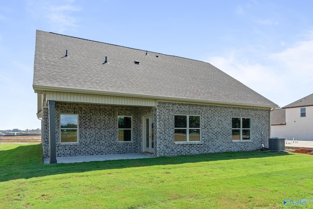 back of house with a yard, a shingled roof, cooling unit, and a patio area
