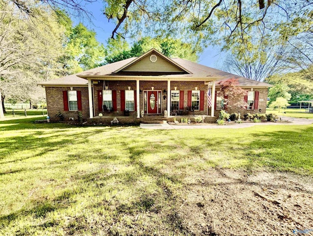 view of front facade with a front lawn, covered porch, and brick siding