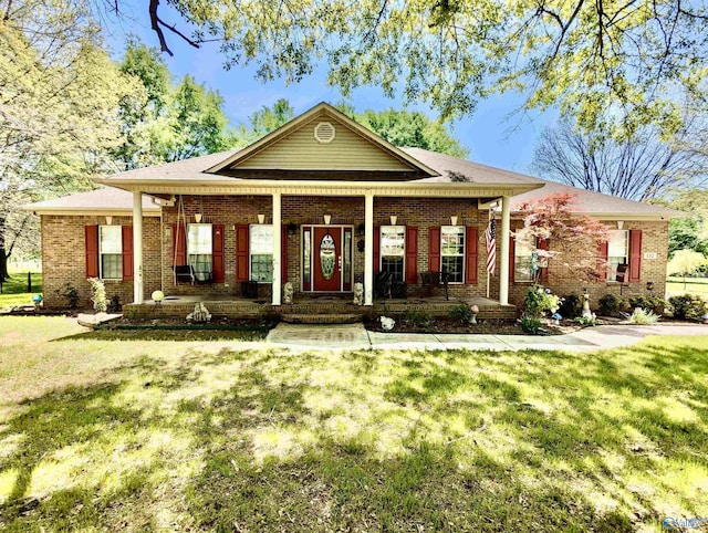 view of front facade with covered porch, brick siding, and a front lawn