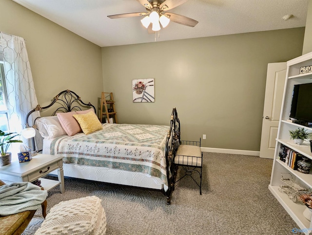 bedroom with a ceiling fan, baseboards, and carpet floors
