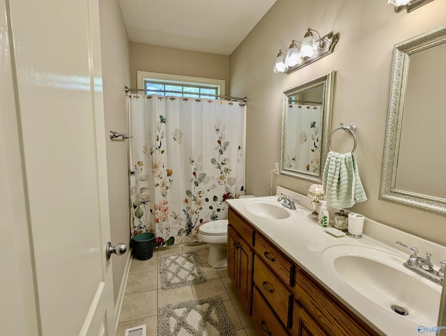 bathroom with toilet, tile patterned flooring, double vanity, and a sink