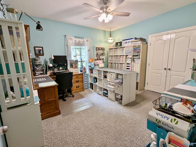 office space with a ceiling fan, carpet, and a textured ceiling