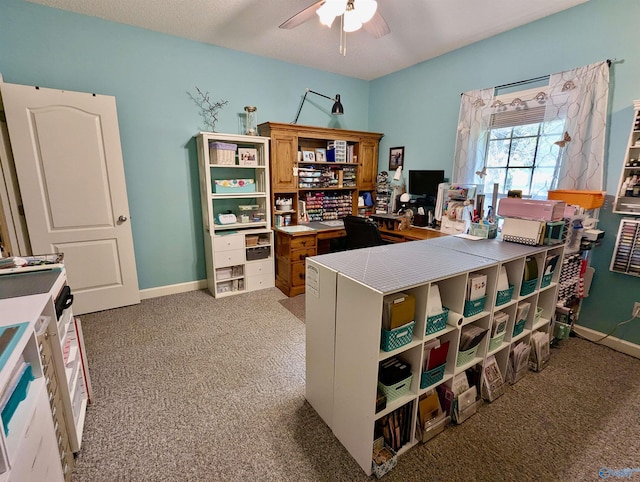 home office featuring baseboards, light carpet, and ceiling fan