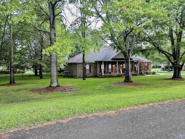 ranch-style house featuring a front yard and brick siding