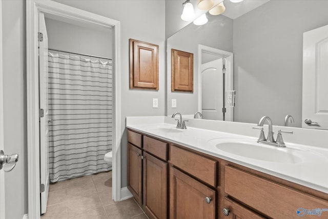 bathroom with vanity, tile patterned floors, and toilet