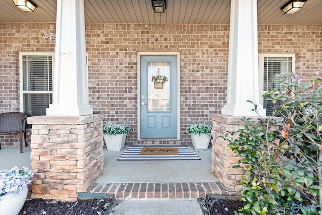 view of exterior entry with covered porch