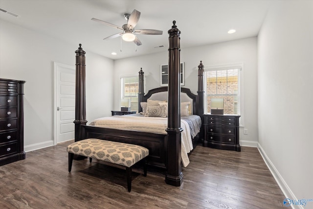 bedroom featuring ceiling fan, dark hardwood / wood-style floors, and multiple windows