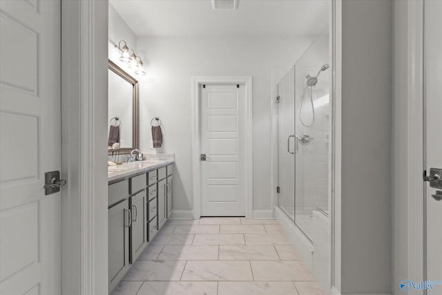 bathroom with a shower with door and vanity