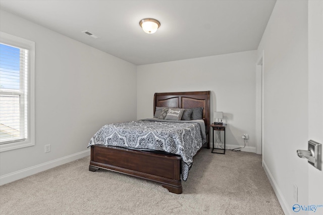 carpeted bedroom featuring multiple windows