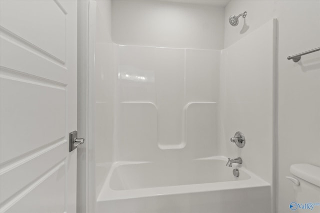 bathroom with toilet and  shower combination