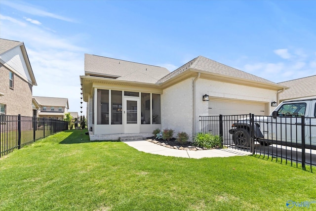 back of property featuring a sunroom and a yard