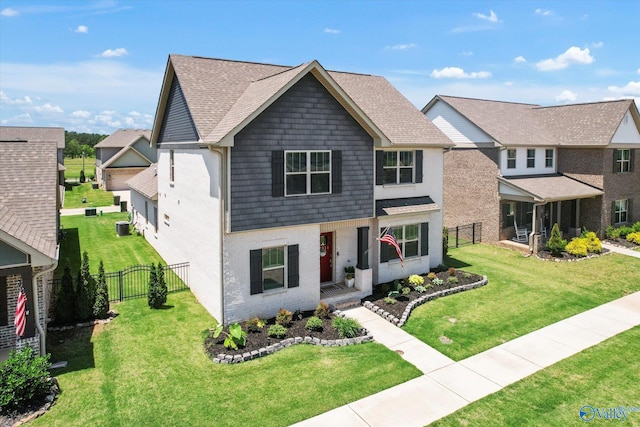 view of front of property with central air condition unit and a front yard