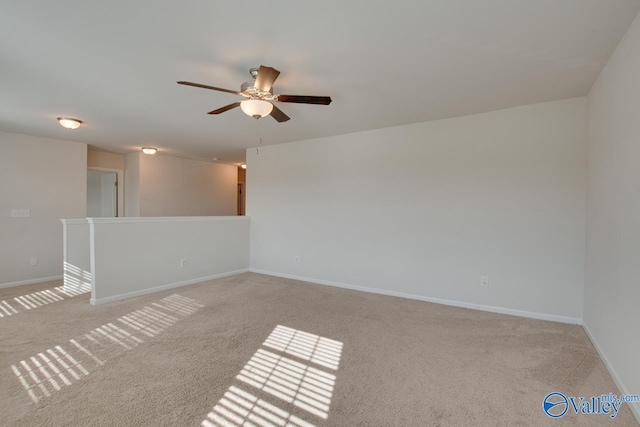 empty room featuring light carpet and ceiling fan