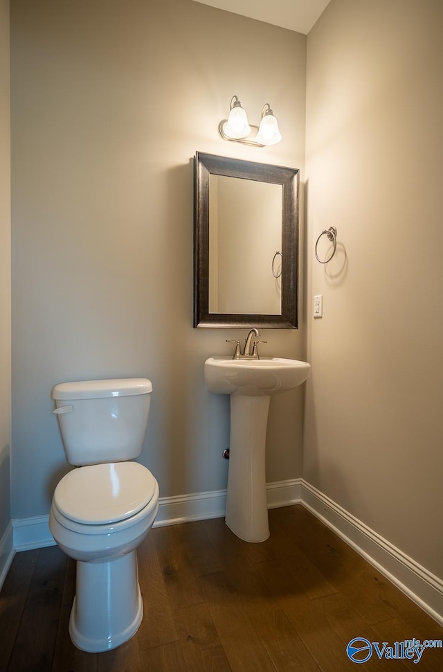 24337 Beacon Cir, Athens, AL 35613 - half bath with baseboards, wood finished floors, and toilet