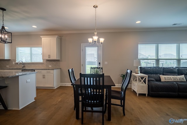 24337 Beacon Cir, Athens, AL 35613 - dining room with a chandelier, dark wood-style floors, crown molding, recessed lighting, and baseboards