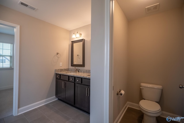 24337 Beacon Cir, Athens, AL 35613 - bathroom with vanity, toilet, baseboards, and tile patterned floors
