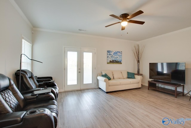 living room featuring ceiling fan, crown molding, french doors, and light wood-type flooring