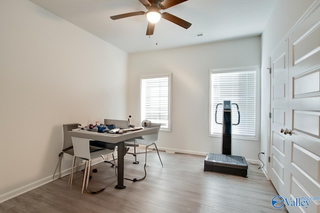 home office with ceiling fan and light wood-type flooring