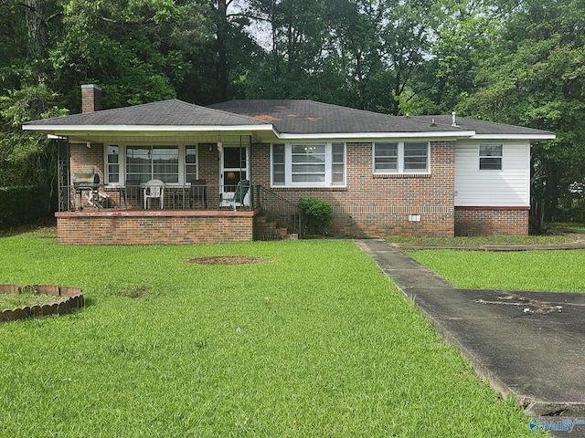 2505 E Broad St, Gadsden, AL 35905 - view of front of house with a porch, a front yard, a chimney, and brick siding
