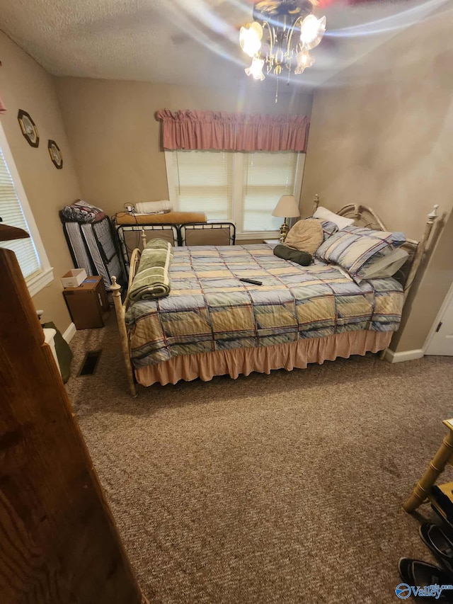 2505 E Broad St, Gadsden, AL 35905 - bedroom with carpet floors, a textured ceiling, a chandelier, a ceiling fan, and baseboards