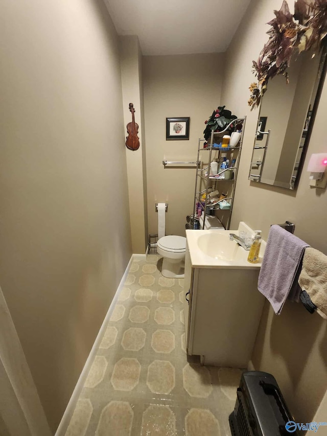 2505 E Broad St, Gadsden, AL 35905 - bathroom with baseboards, toilet, and vanity