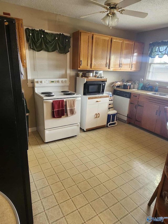 2505 E Broad St, Gadsden, AL 35905 - kitchen with black appliances, a textured ceiling, light countertops, ceiling fan, and a sink