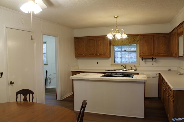 kitchen featuring pendant lighting, sink, dishwasher, a kitchen island, and black gas stovetop