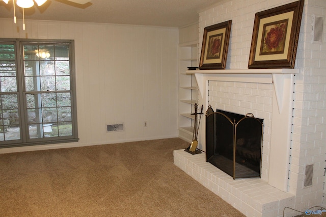 living room with visible vents, a healthy amount of sunlight, a brick fireplace, and carpet