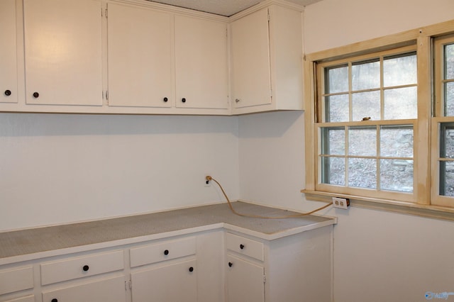 kitchen with white cabinetry and light countertops