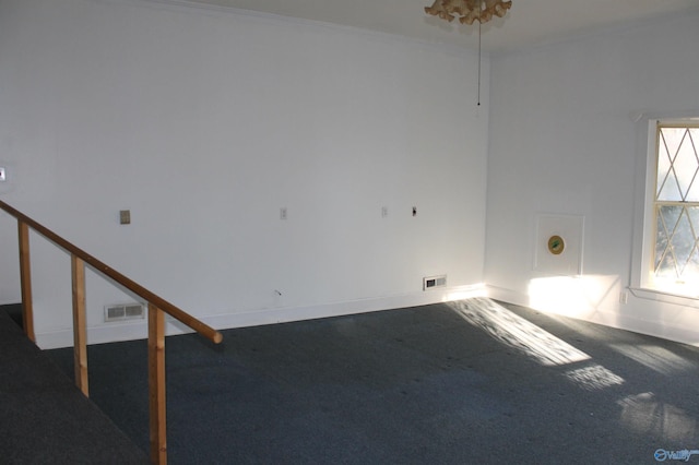 carpeted spare room featuring ornamental molding