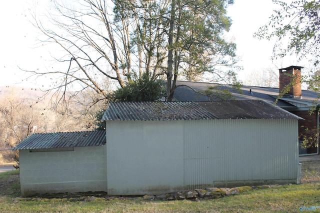 view of property exterior with metal roof and a chimney