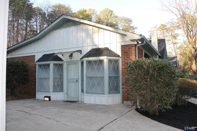 exterior space with brick siding and board and batten siding