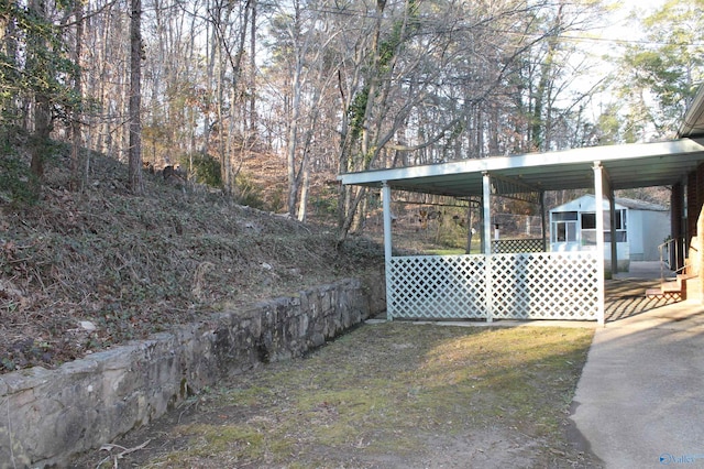 view of yard with a carport and a shed